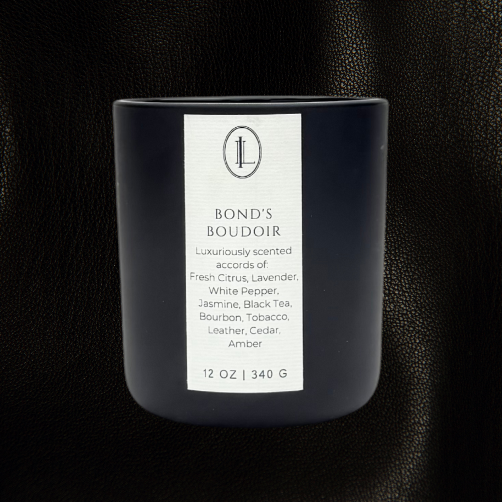Bond's Boudoir labeled wood wick in a matte black vessel on a dark textured background