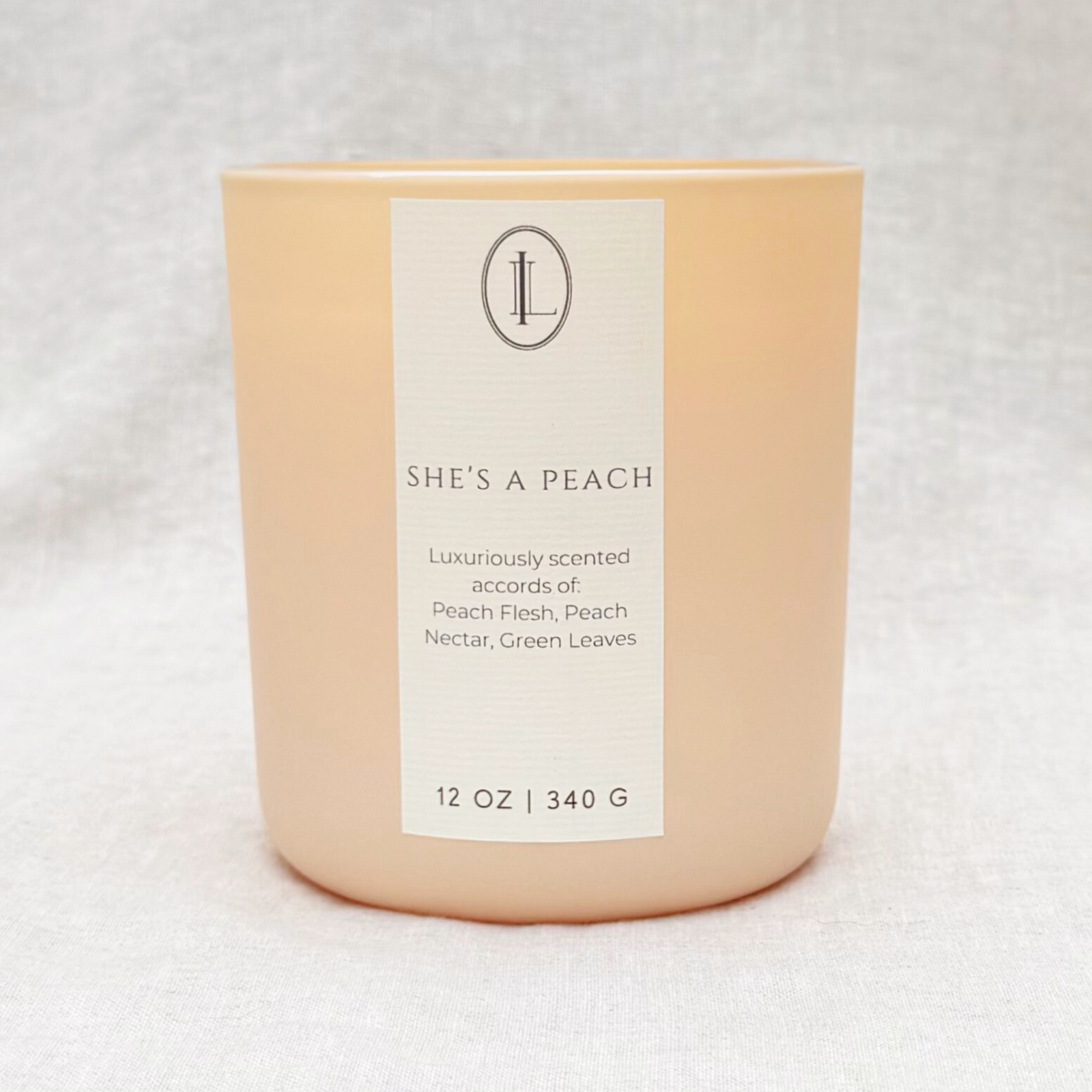 Juicy Peach Scented Wood Wick Candle in a matte peach glass vessel