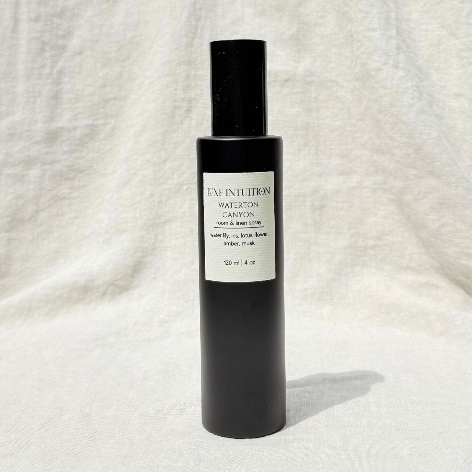 Aquatic room & linen spray in a black spray bottle on a linen background