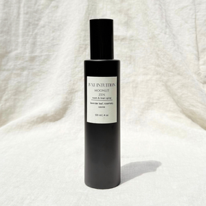 Lavender scented room and linen spray in a black spray bottle on a linen background