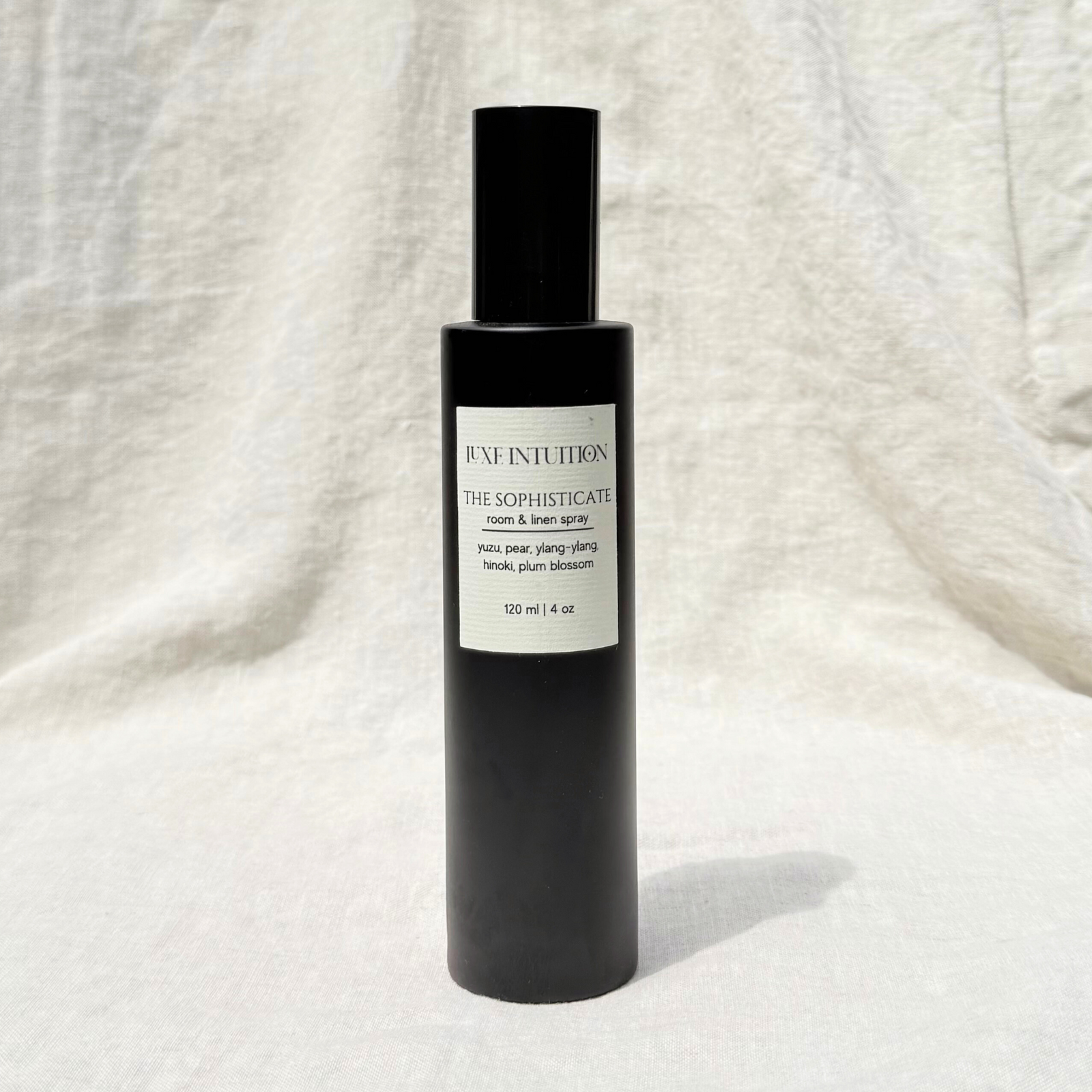 Yuzu & Pear scented room & linen spray in a black bottle on a linen background