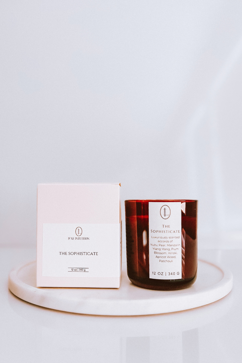 The Sophisticate Candle next to box