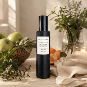 Hand-blended Farmers Market linen spray styled with green apples, fresh basil, clementines, and thyme — Colorado-made limited edition