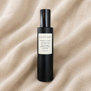 Limited-edition Farmers Market room spray with basil and sage resting on natural linen fabric