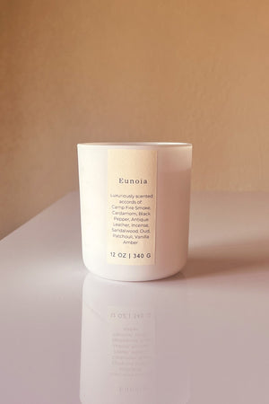 Eunoia scented wooden wick candle scented with vegan friendly essential oils.