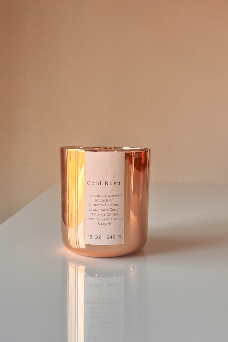 Metallic Gold Candle. Scent is called Gold Rush featuring vegan friendly oils of grapefruit, labdanum, lemon, cedar. coumarin, nutmeg, ginger, jasmine, sandalwood, amber, & myrrh.