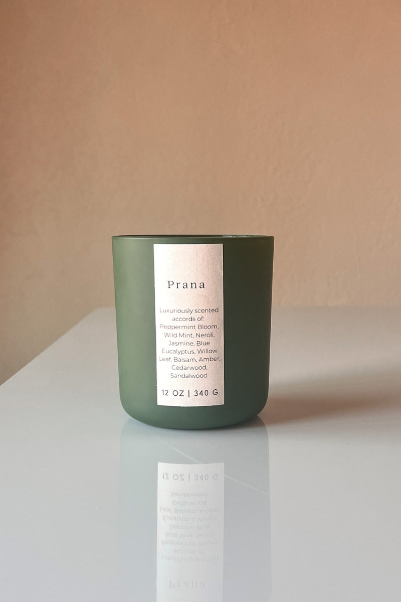 Prana wooden wick candle, a spa fragrance that is relaxing to the senses.