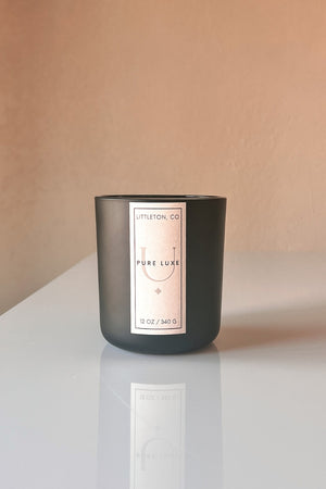 Pure Luxe Scented Wooden Wick Candle featuring vegan friendly oils of orange marmalade, tamarind, honey, burbon, coumarin, clove, brown sugar, & tobaco